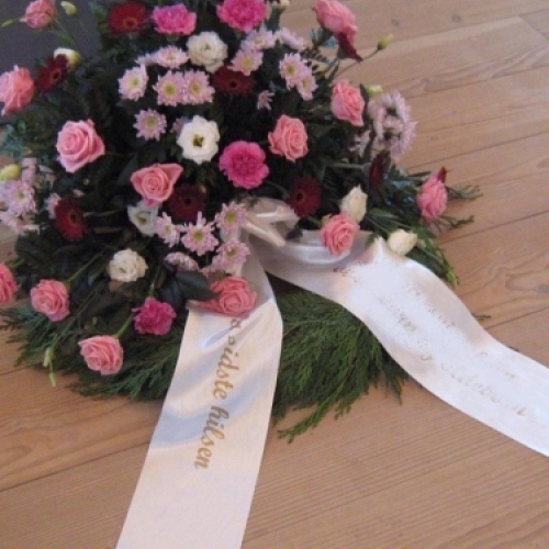 Begravelseskrans med pink og rosa blomster med bånd